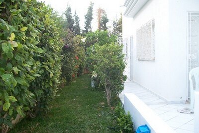 a beautiful villa style amrecain with a garden and a carport